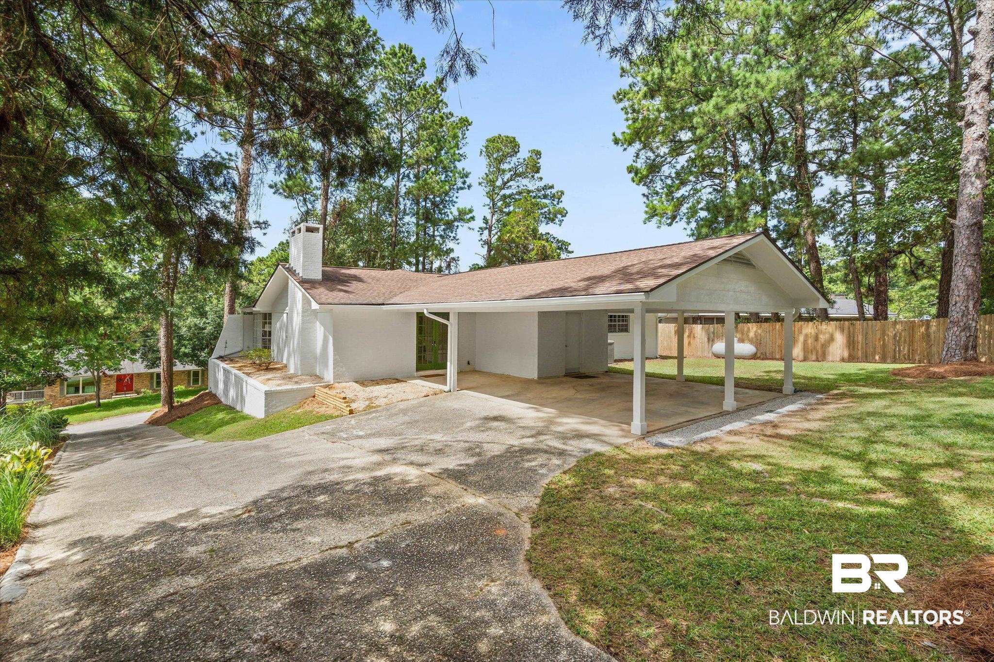 9 Bull Run Road Spanish Fort, AL 36527 - Photo 21 of 23 Contemporary ranch-style residence featuring a white brick exterior, a covered carport, and a brown shingle roof