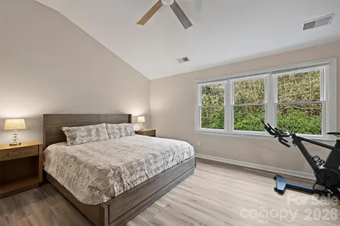 a bedroom with a bed and a view of ceiling fan