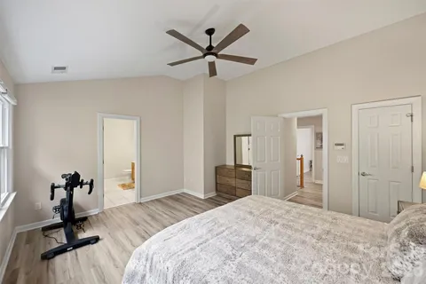 a bedroom with a bed and a chandelier