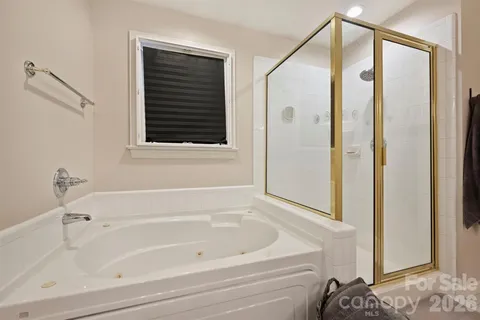a bathroom with a bathtub and a shower