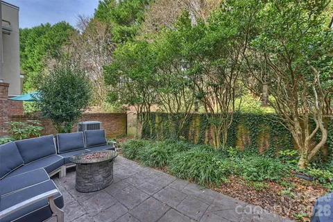 a view of backyard with outdoor seating and green space