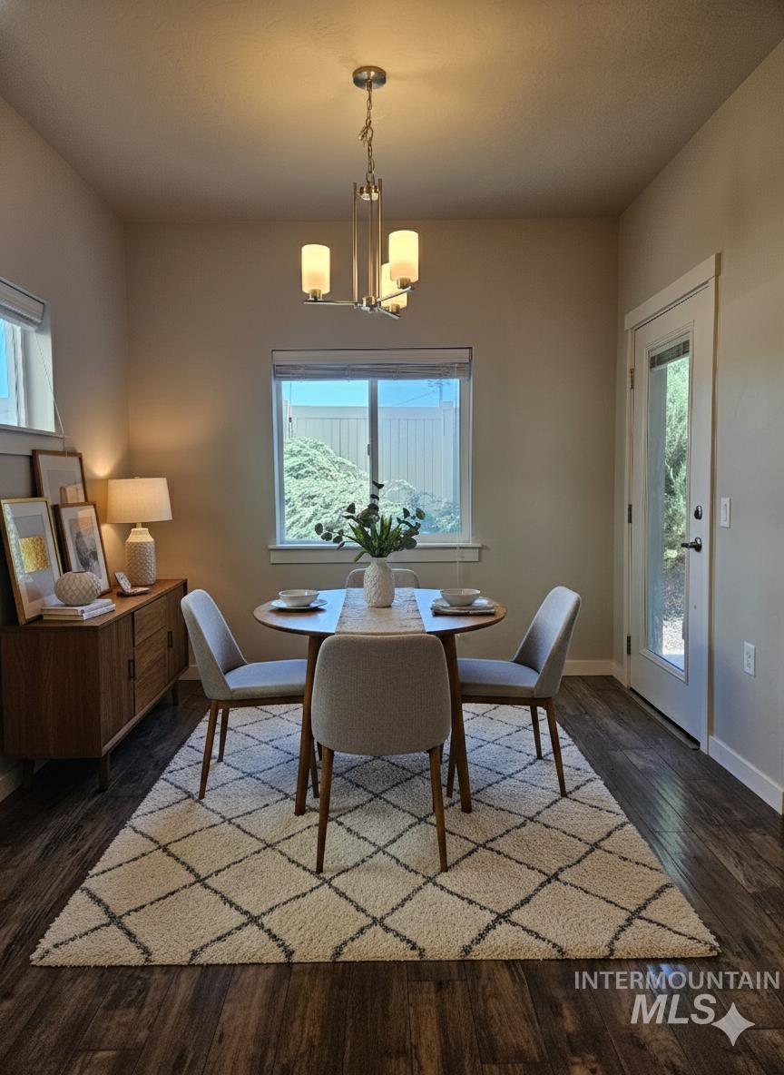 324 Northwest 3rd Street Meridian, ID 83642 - Photo 12 of 13 Dining space with dark wood-style flooring and hanging lights
