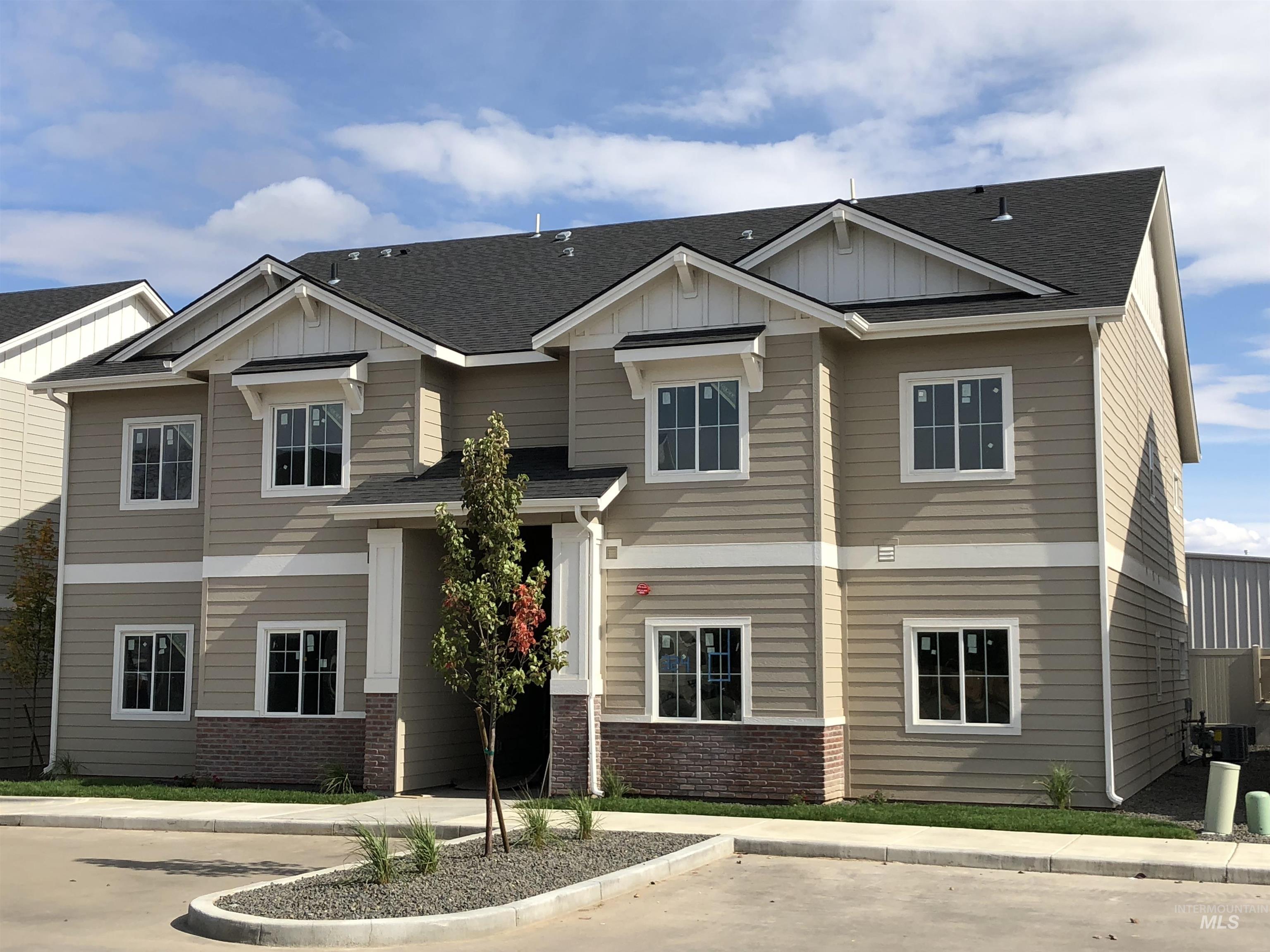 324 Northwest 3rd Street Meridian, ID 83642 - Photo 2 of 12 Craftsman-style house with board and batten siding, roof with shingles, and brick siding