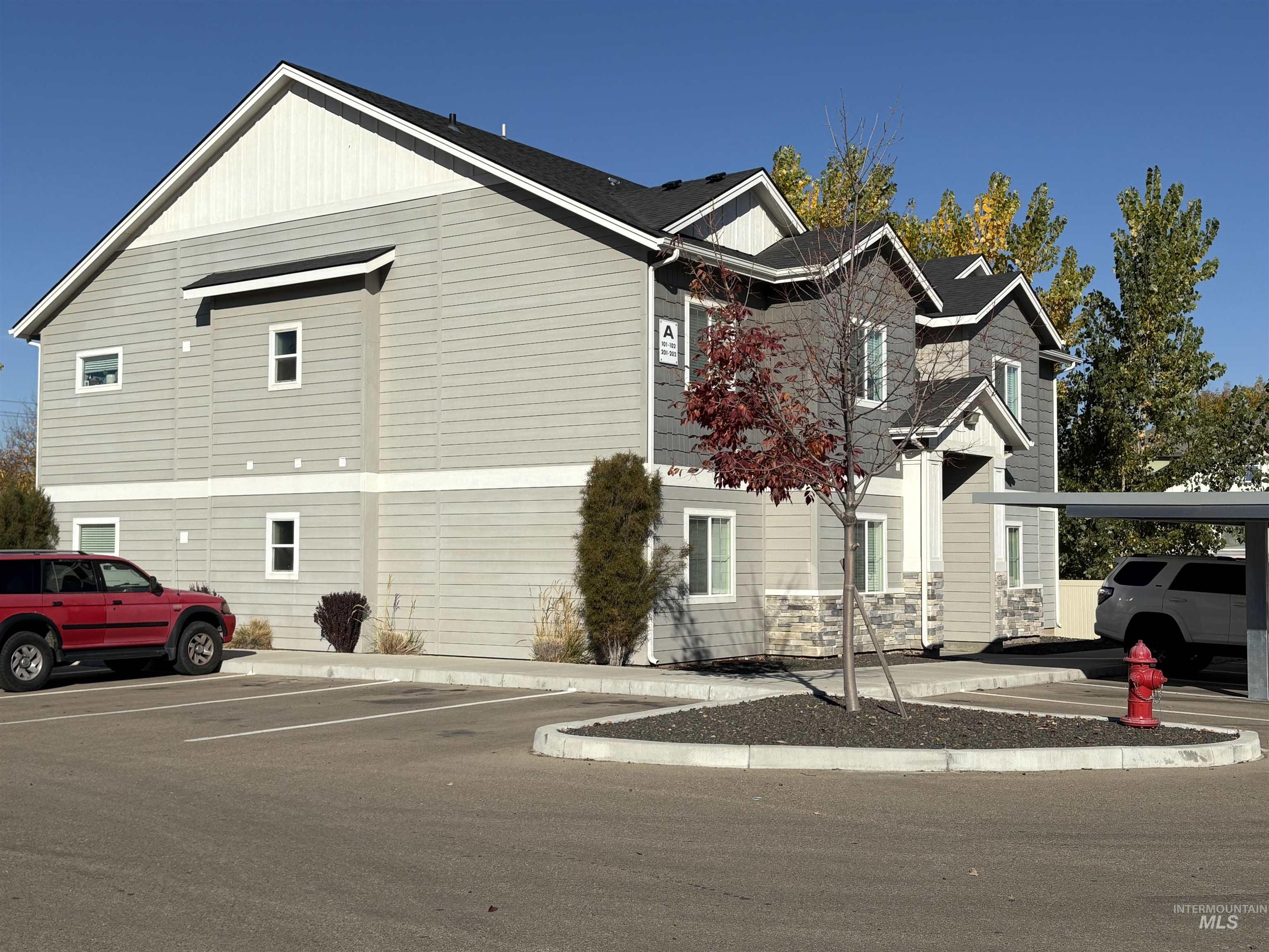 324 Northwest 3rd Street Meridian, ID 83642 - Photo 10 of 12 View of side of home with uncovered parking and board and batten siding
