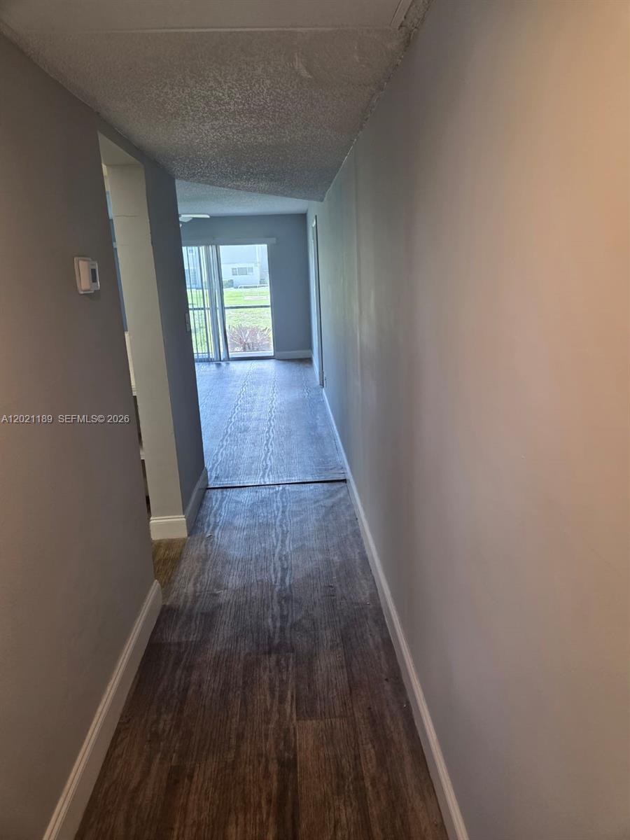 8060 North Colony Circle, Unit 103 Tamarac, FL 33321 - Photo 4 of 8 a view of hallway with wooden floor
