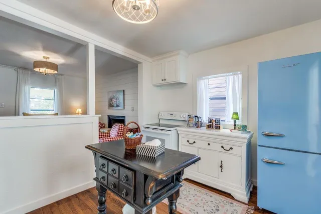 a kitchen with a sink cabinets and wooden floor
