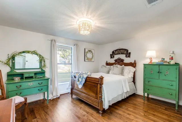 a bedroom with a bed and a dresser