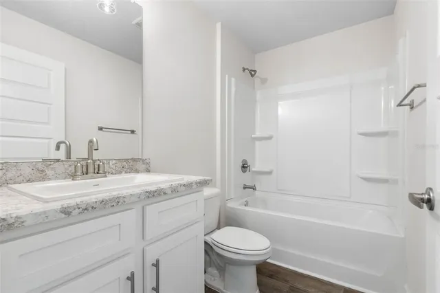 an empty room with white cabinet and closet