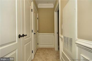 12824 Clarksburg Square Road, Unit 208 Clarksburg, MD 20871 - Photo 11 of 20 a view of a hallway with a wooden door