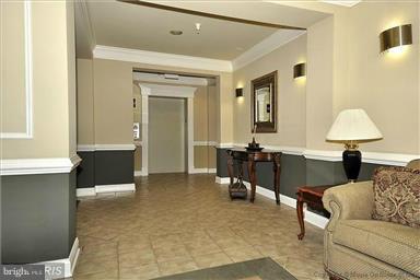 12824 Clarksburg Square Road, Unit 208 Clarksburg, MD 20871 - Photo 15 of 20 a living room with furniture and a table