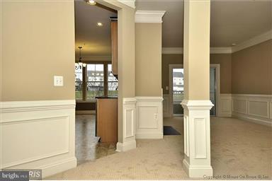 12824 Clarksburg Square Road, Unit 208 Clarksburg, MD 20871 - Photo 2 of 20 a view of hallway with furniture and a chandelier