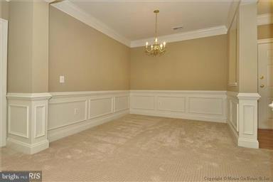 12824 Clarksburg Square Road, Unit 208 Clarksburg, MD 20871 - Photo 5 of 20 en empty room with chandelier fan