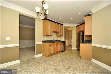 12824 Clarksburg Square Road, Unit 208 Clarksburg, MD 20871 - Photo 7 of 20 a large kitchen with a refrigerator a stove top oven a sink and dishwasher