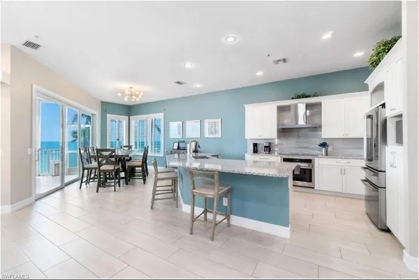 a kitchen with granite countertop a sink stove top oven and cabinets