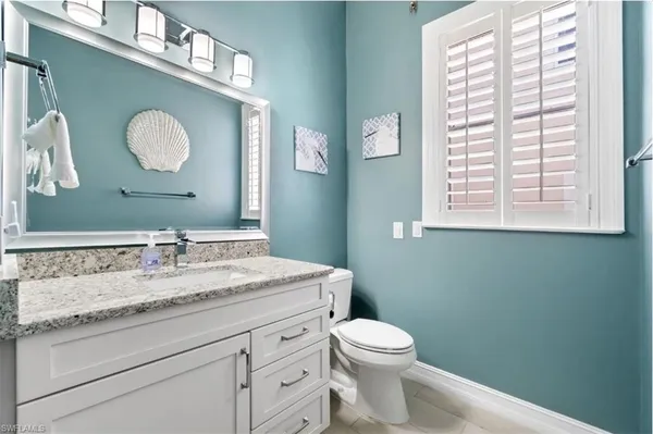 a large bedroom with a bed and a dresser