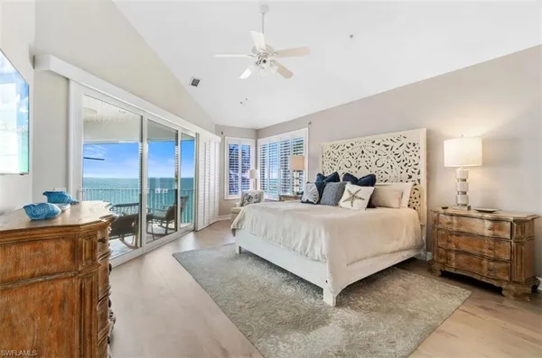 a living room with furniture and a floor to ceiling window