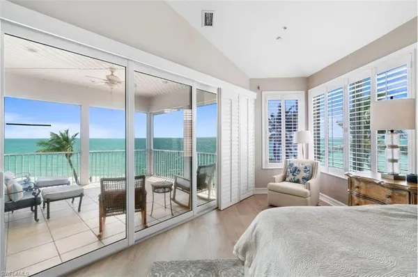 a living room with furniture and a floor to ceiling window