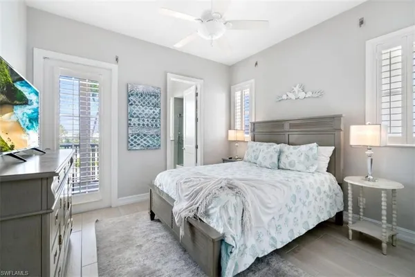 a bedroom with a bed and a large mirror