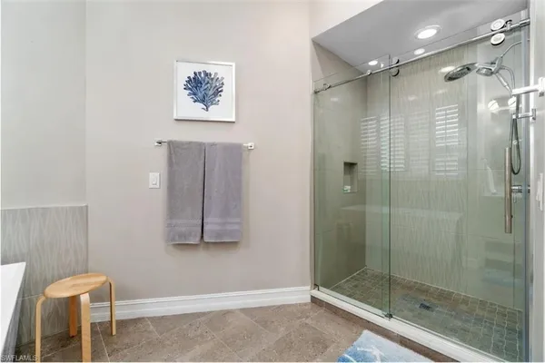 a bedroom with furniture a baby crib and a window