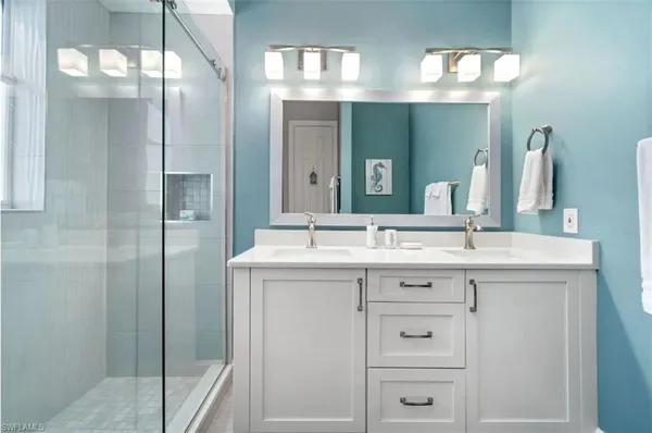 a bathroom with a sink a toilet and a window