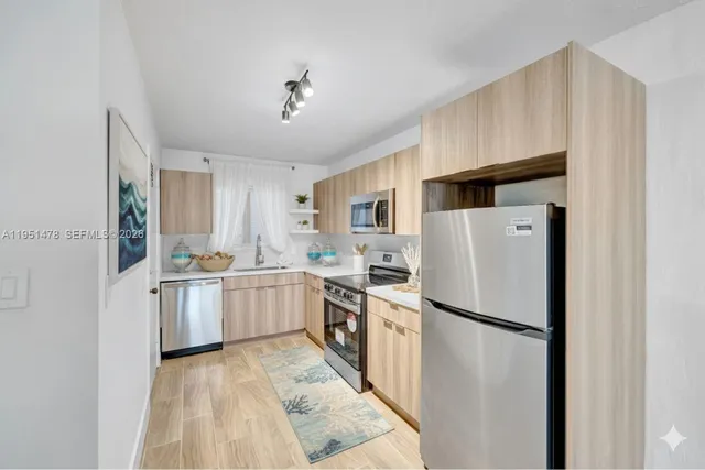 a kitchen with a refrigerator a sink and dishwasher