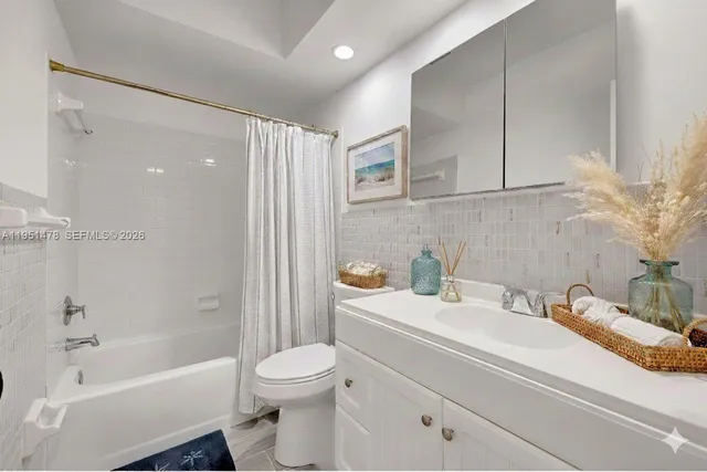 a bathroom with a sink a toilet and a bathtub