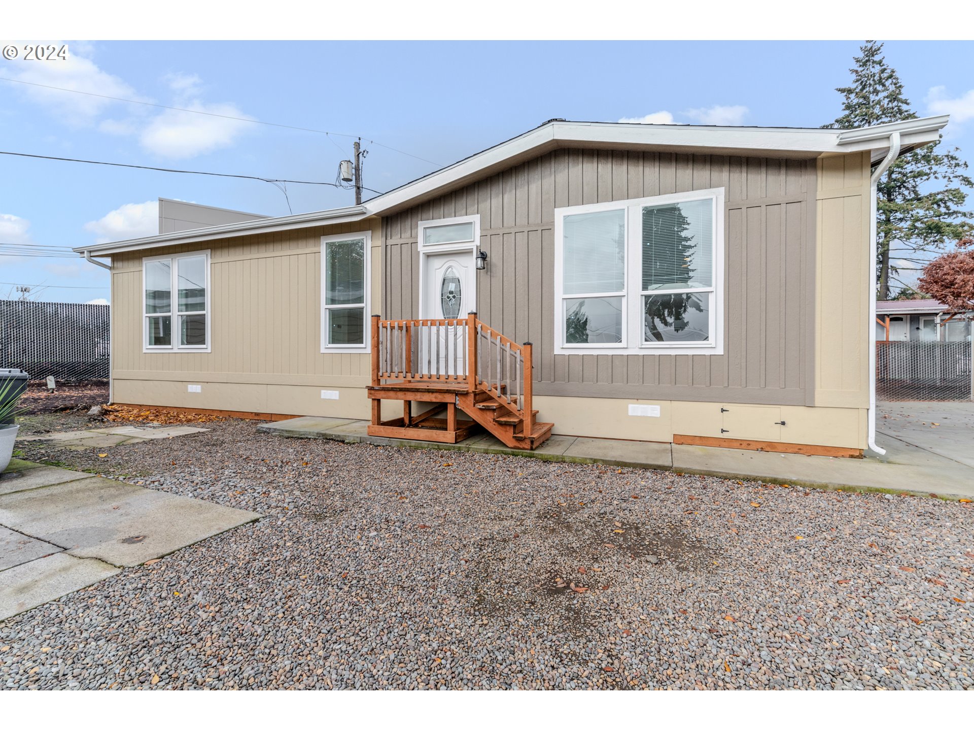 9700 Southwest Tualatin Road, Unit 22 Tualatin, OR 97062 - Photo 1 of 30 a front view of a house with a yard