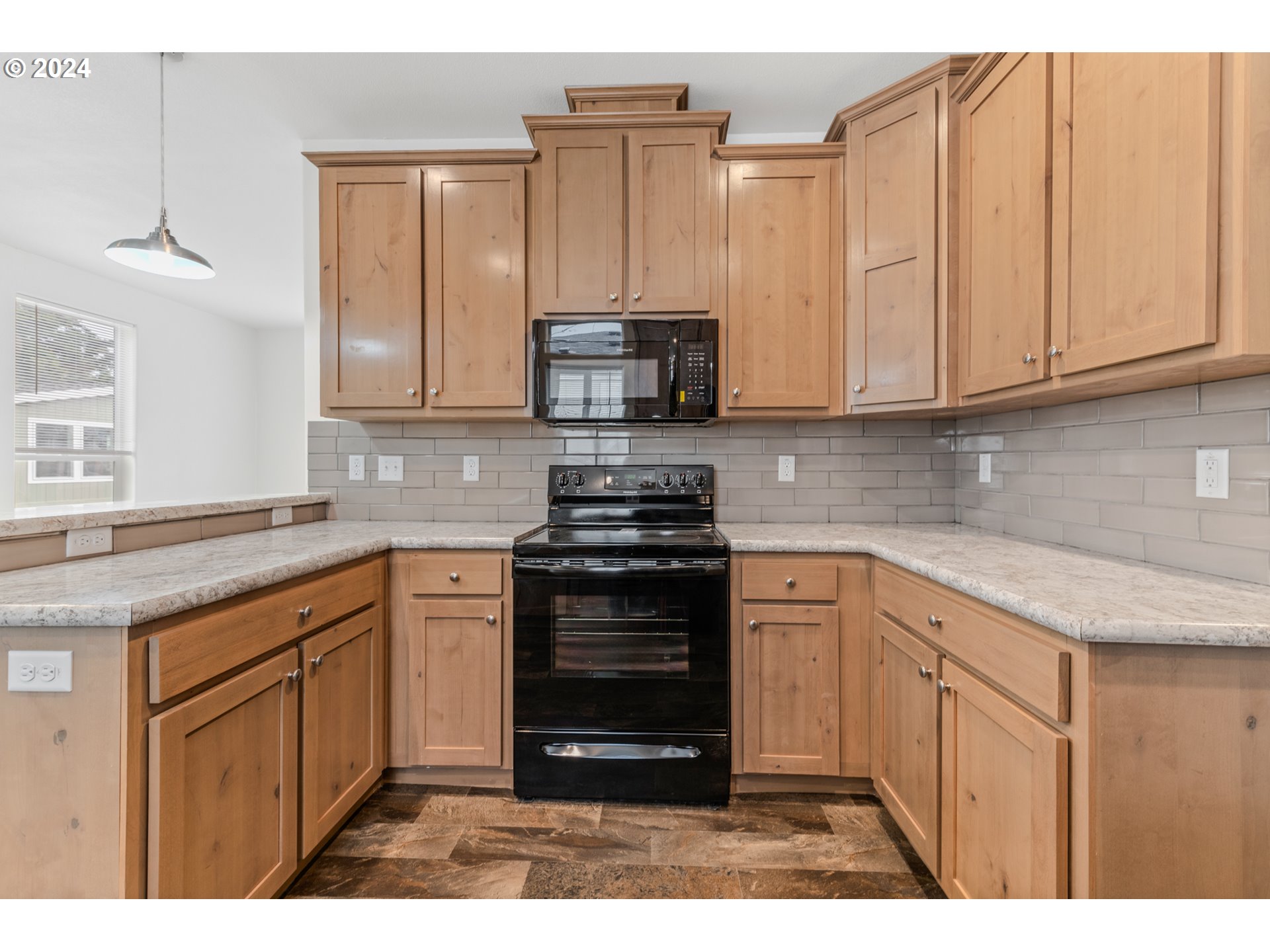 9700 Southwest Tualatin Road, Unit 22 Tualatin, OR 97062 - Photo 12 of 30 a kitchen with stainless steel appliances granite countertop a stove a sink and a microwave