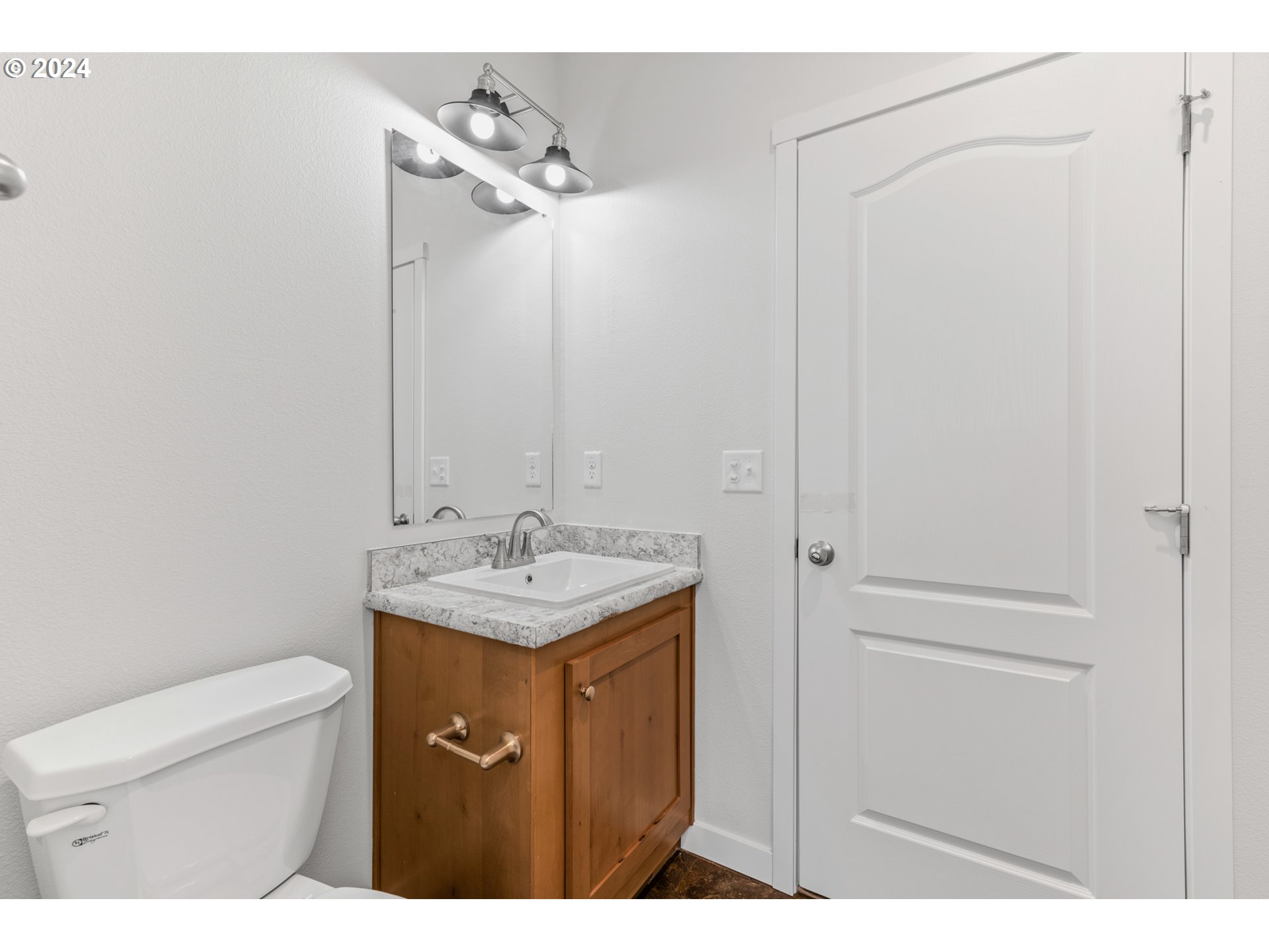 9700 Southwest Tualatin Road, Unit 22 Tualatin, OR 97062 - Photo 13 of 30 a bathroom with a granite countertop sink a toilet and a mirror