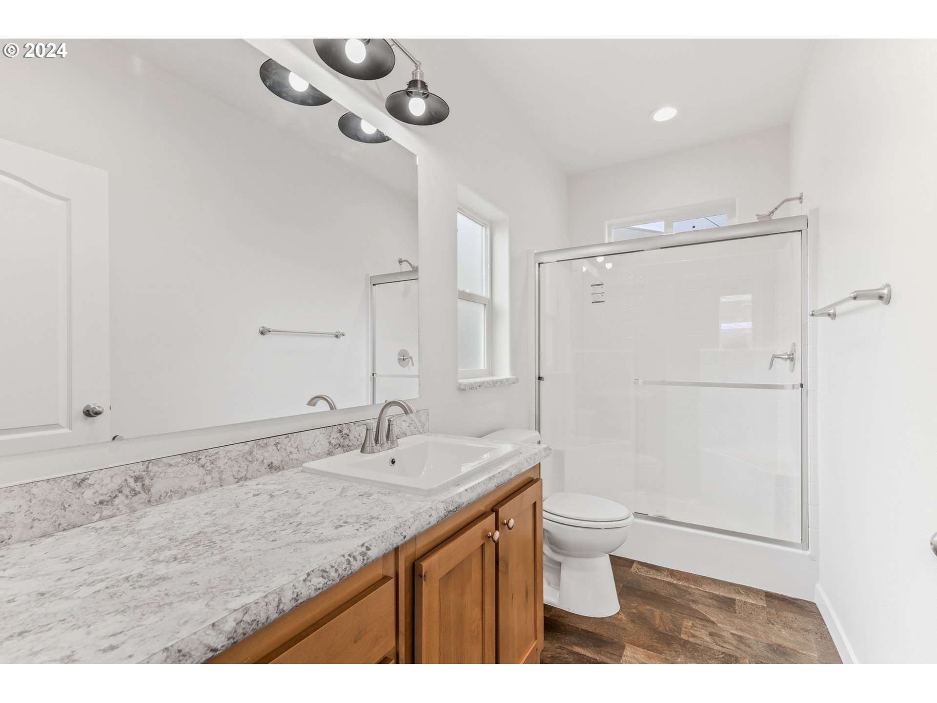 9700 Southwest Tualatin Road, Unit 22 Tualatin, OR 97062 - Photo 22 of 30 a bathroom with a granite countertop sink a toilet and shower