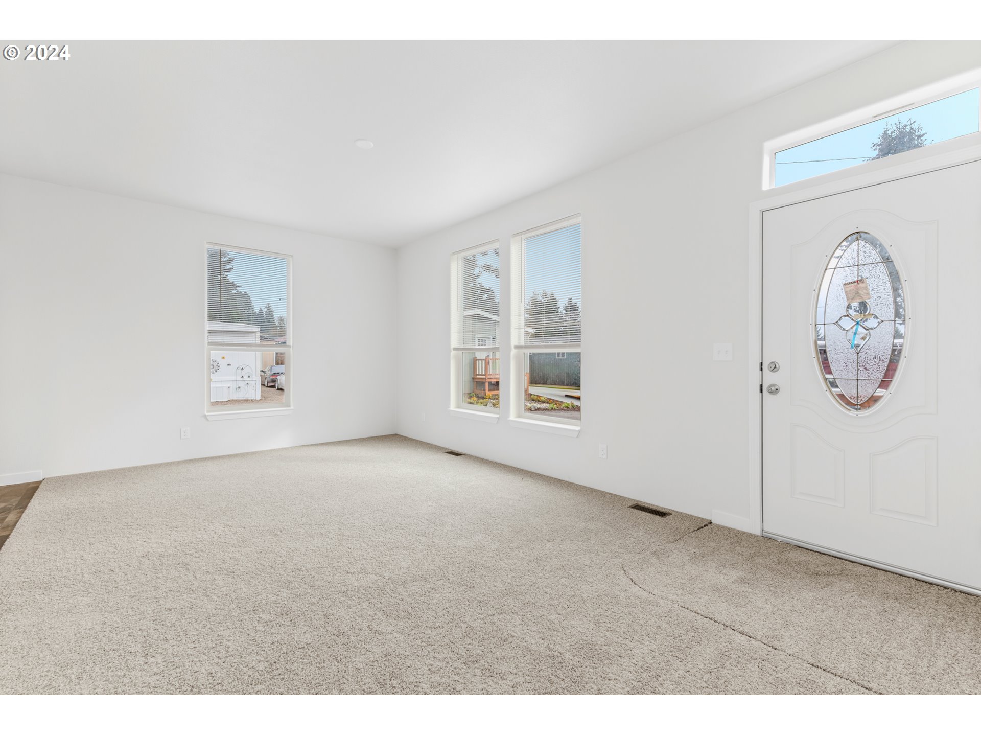 9700 Southwest Tualatin Road, Unit 22 Tualatin, OR 97062 - Photo 3 of 30 a big room with painting on the wall and a window