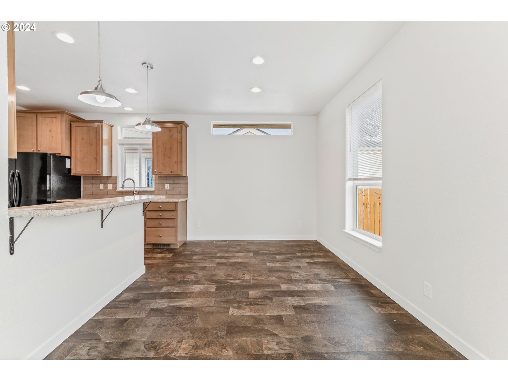 9700 Southwest Tualatin Road, Unit 22 Tualatin, OR 97062 - Photo 6 of 30 a view of a kitchen with a sink cabinets and a window