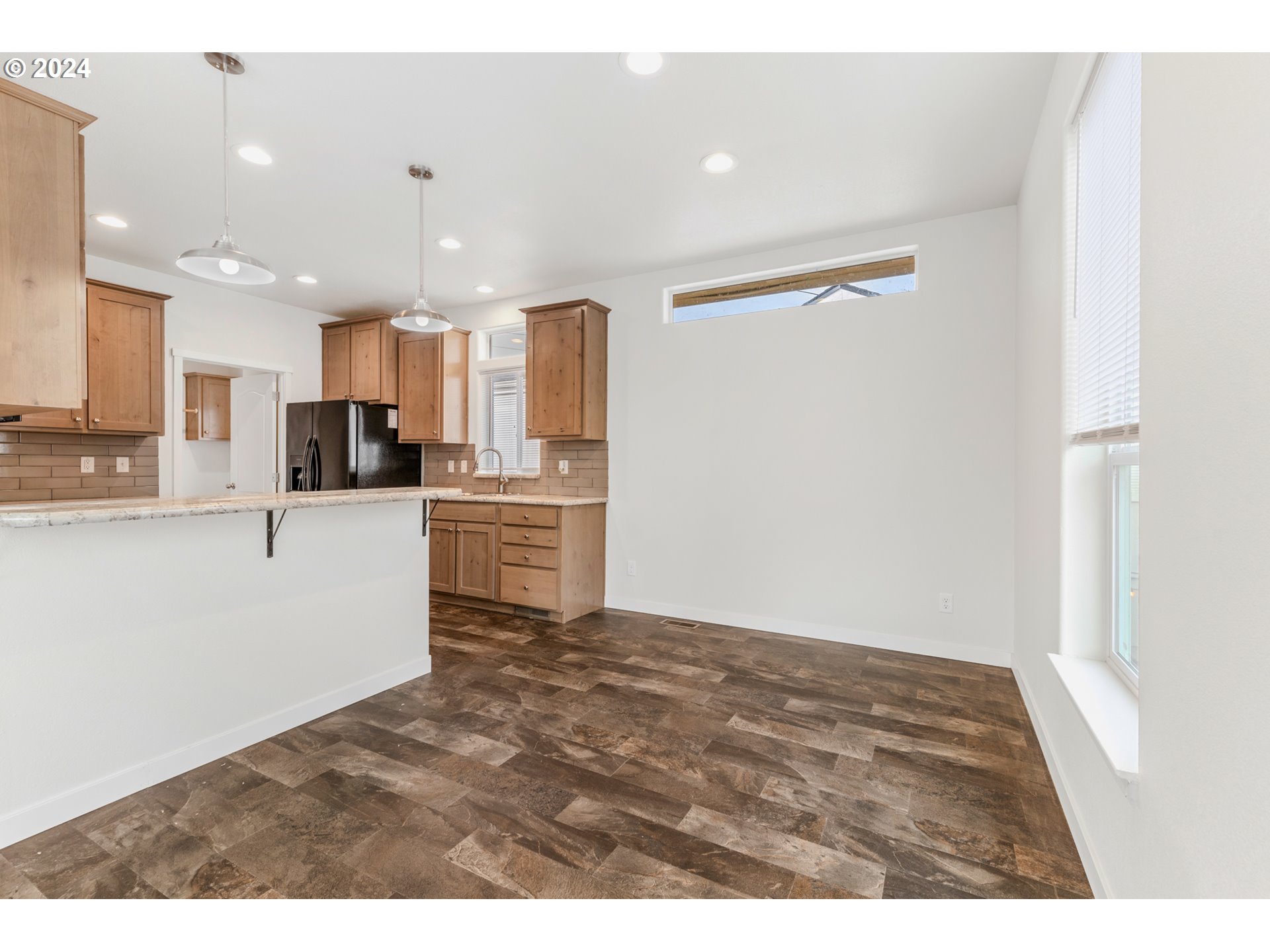 9700 Southwest Tualatin Road, Unit 22 Tualatin, OR 97062 - Photo 7 of 30 a kitchen with stainless steel appliances granite countertop a refrigerator sink and white cabinets