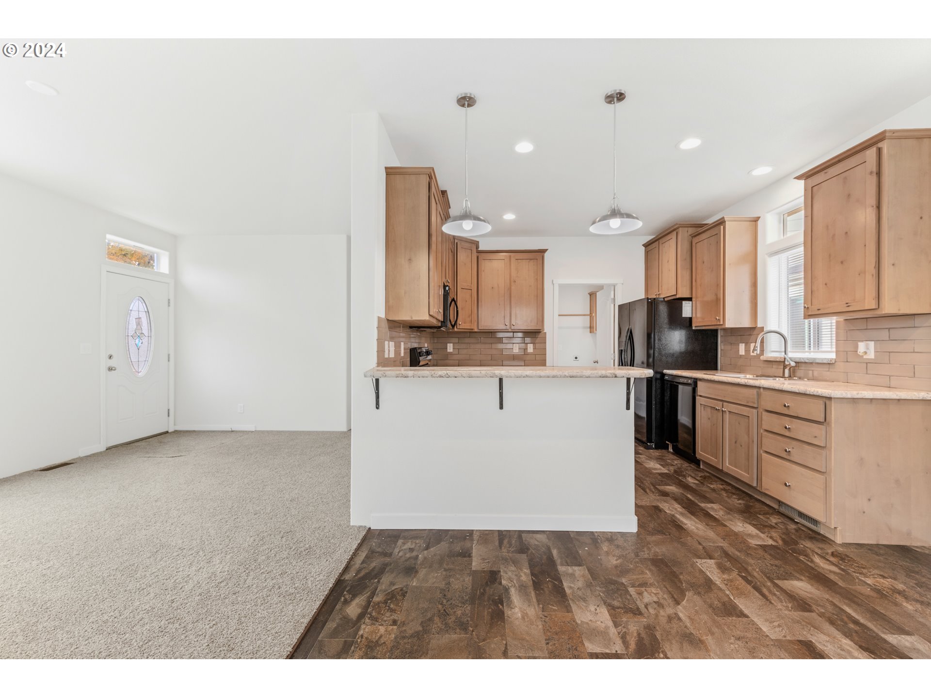 9700 Southwest Tualatin Road, Unit 22 Tualatin, OR 97062 - Photo 8 of 30 a large white kitchen with a refrigerator a stove top oven a sink and white cabinets