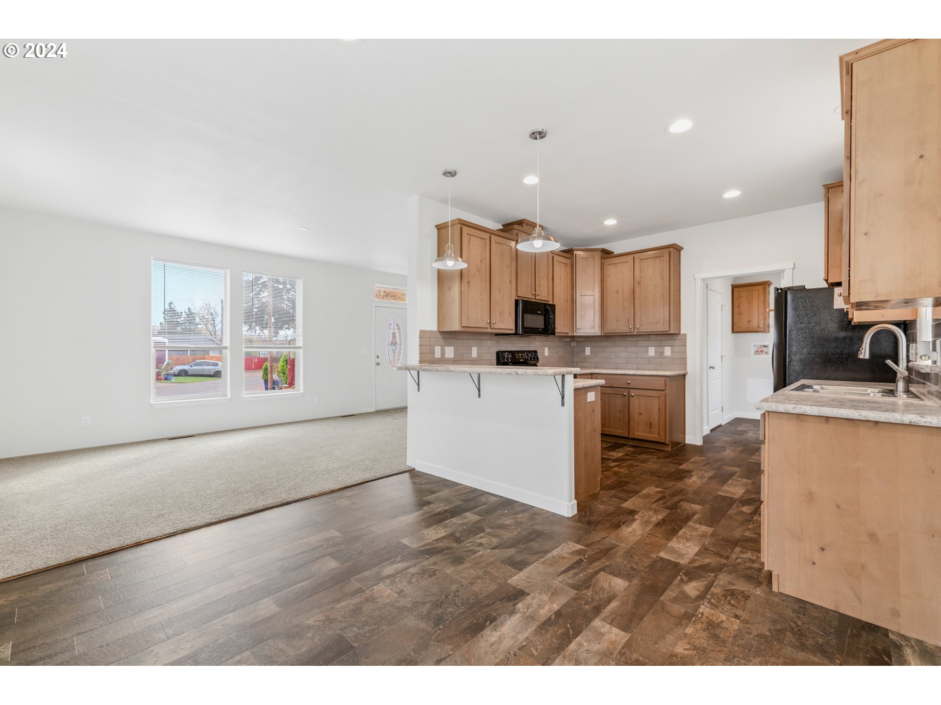 9700 Southwest Tualatin Road, Unit 22 Tualatin, OR 97062 - Photo 9 of 30 a kitchen with stainless steel appliances kitchen island granite countertop a stove a sink and a refrigerator