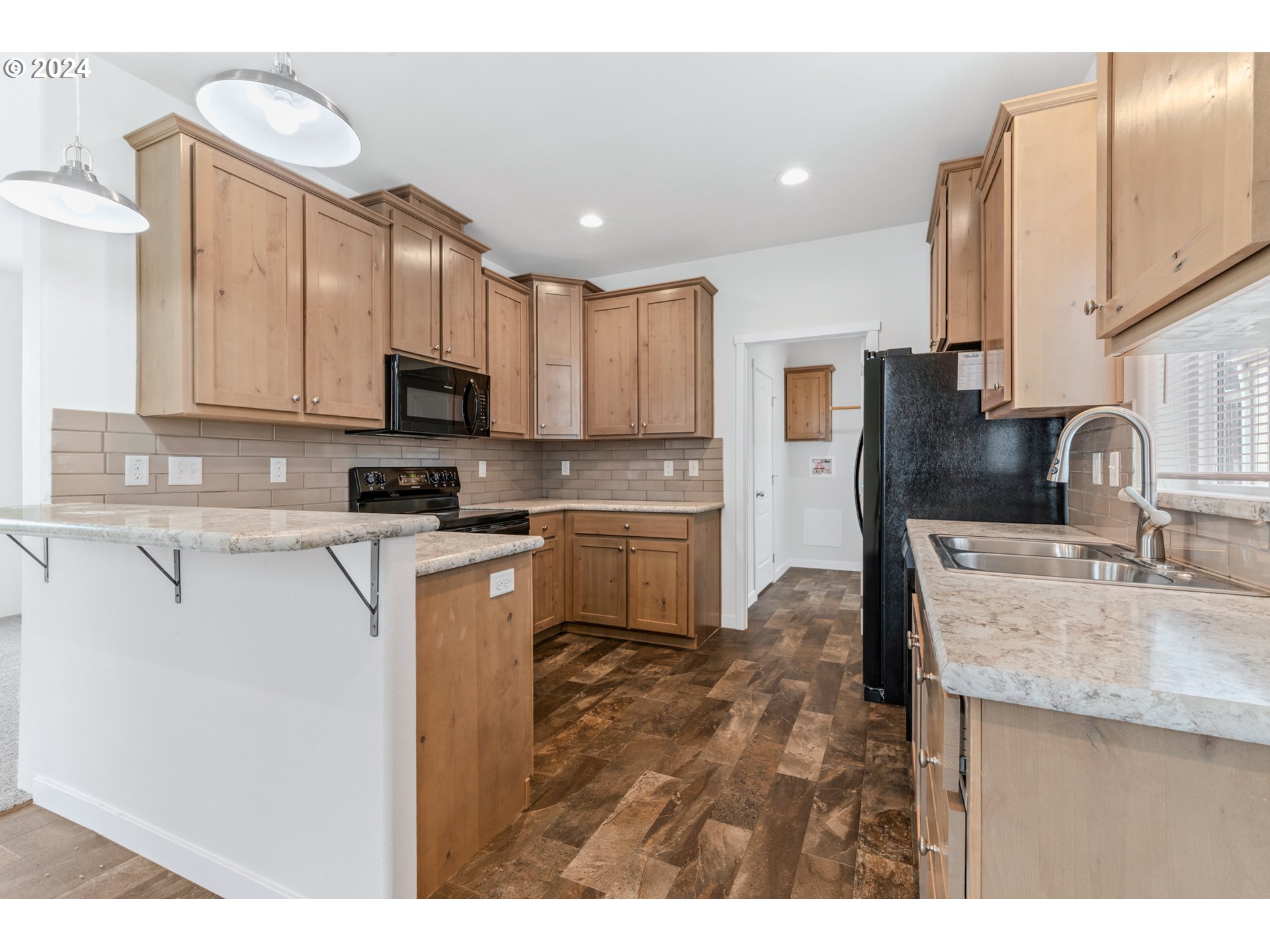 9700 Southwest Tualatin Road, Unit 22 Tualatin, OR 97062 - Photo 10 of 30 a kitchen with stainless steel appliances granite countertop a sink refrigerator and microwave