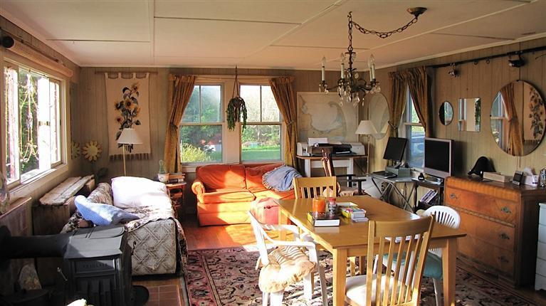 4 Pond Road, Unit 1 2 3 Truro, MA 02666 - Photo 11 of 19 a living room with furniture a large window and chandelier