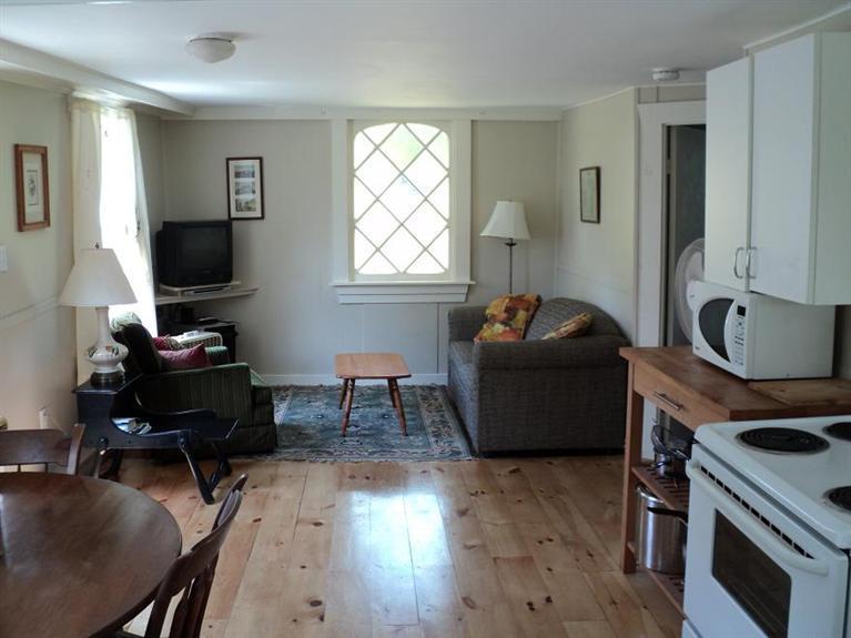 4 Pond Road, Unit 1 2 3 Truro, MA 02666 - Photo 16 of 19 a living room with furniture and a flat screen tv