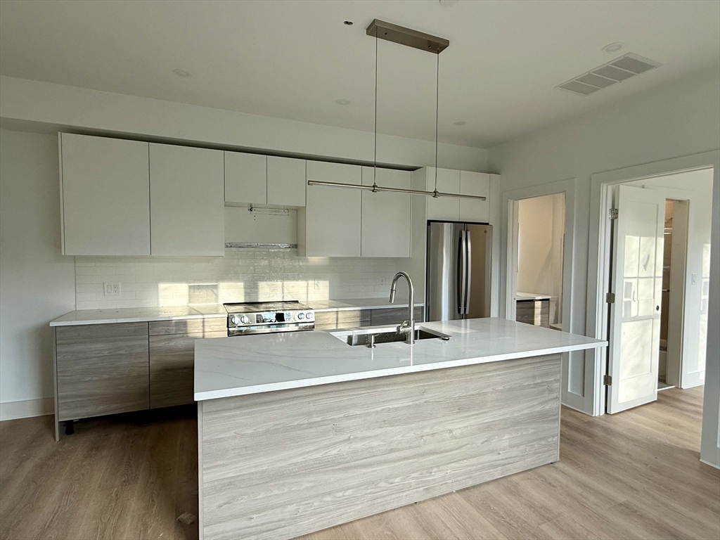 a view of a kitchen counter space with wooden floor