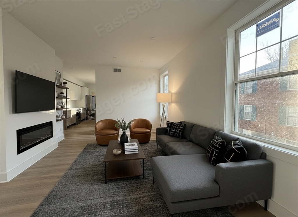 49 Chase Street, Unit 3 Newton, MA 02459 - Photo 6 of 12 a living room with furniture a flat screen tv and a fireplace