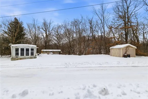 a view of a house with a snow in the yard
