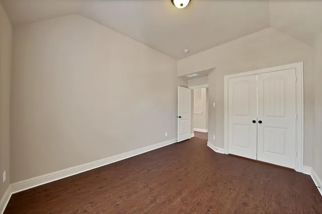 a view of an empty room and closet area