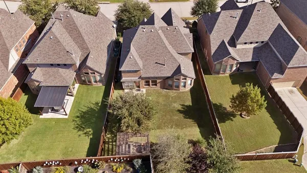 an aerial view of a residential houses with outdoor space