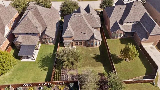 an aerial view of a residential houses with outdoor space