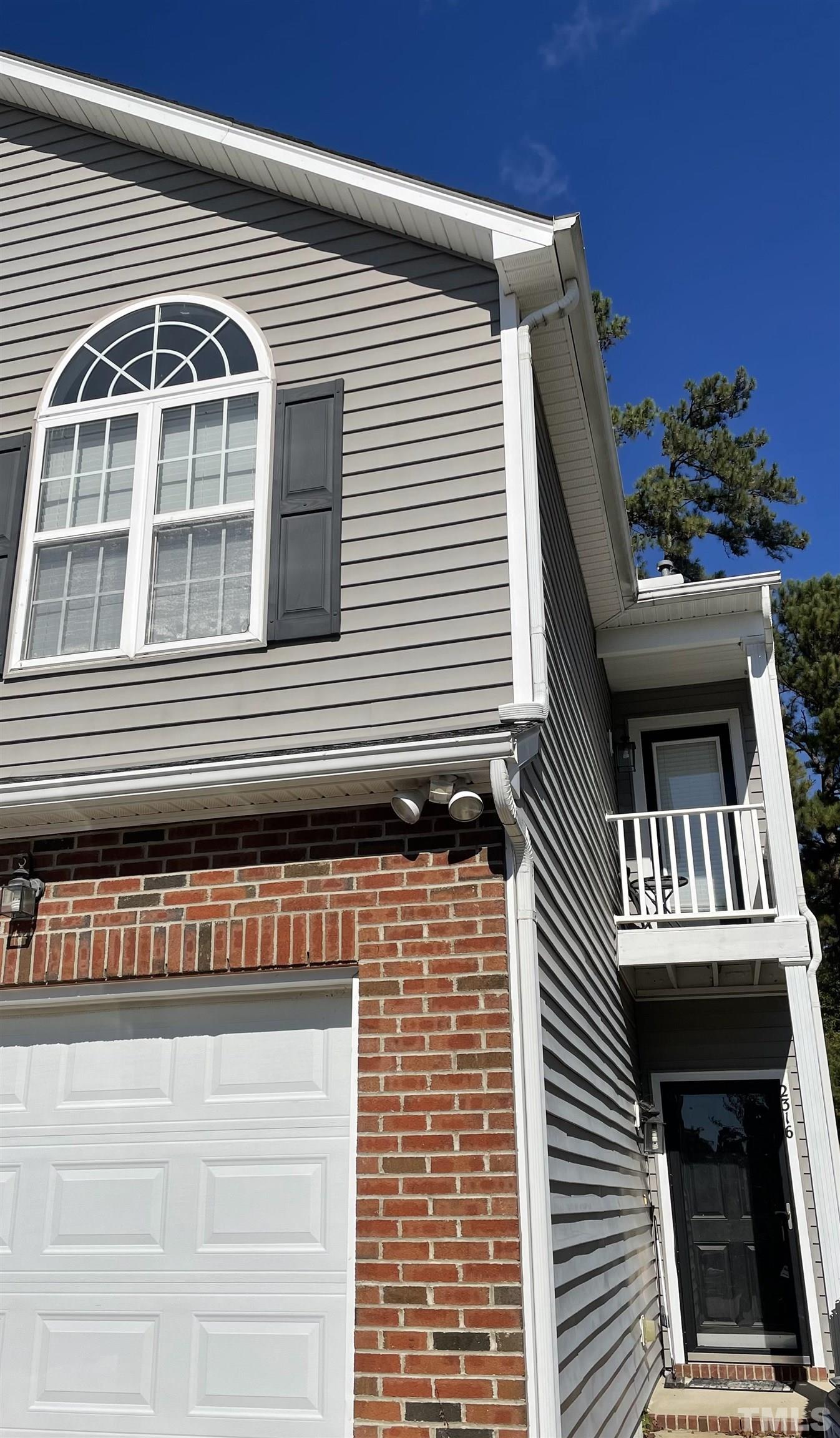 2316 Persimmon Ridge Drive Raleigh, NC 27604 - Photo 1 of 16 a front view of a house with a balcony