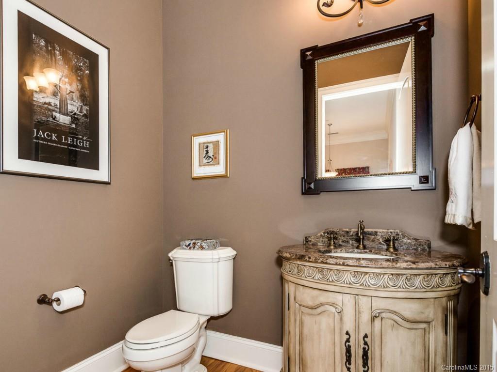 2823 Providence Road, Unit 180 Charlotte, NC 28211 - Photo 13 of 24 a bathroom with a granite countertop toilet sink and mirror