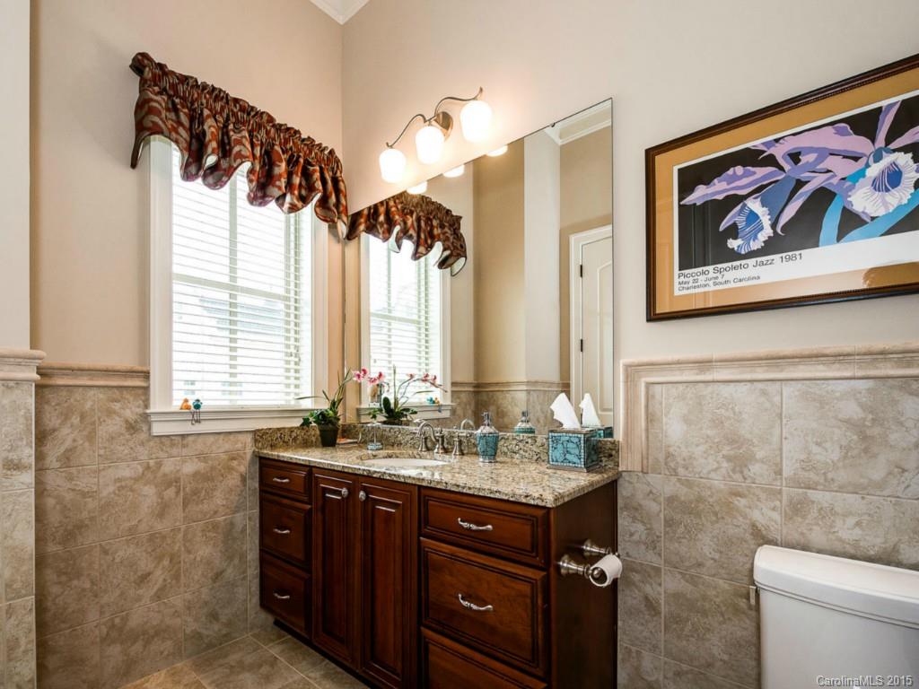 2823 Providence Road, Unit 180 Charlotte, NC 28211 - Photo 18 of 24 a bathroom with a granite countertop sink a large mirror and a window