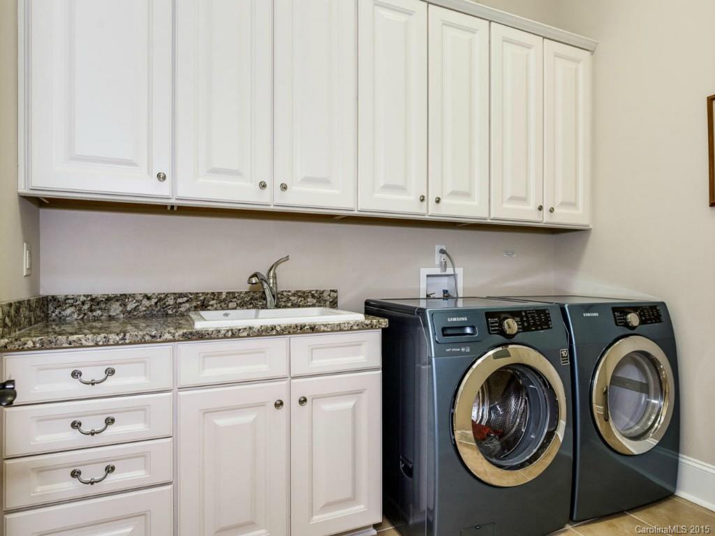 2823 Providence Road, Unit 180 Charlotte, NC 28211 - Photo 21 of 24 a kitchen with granite countertop white cabinets and stainless steel appliances