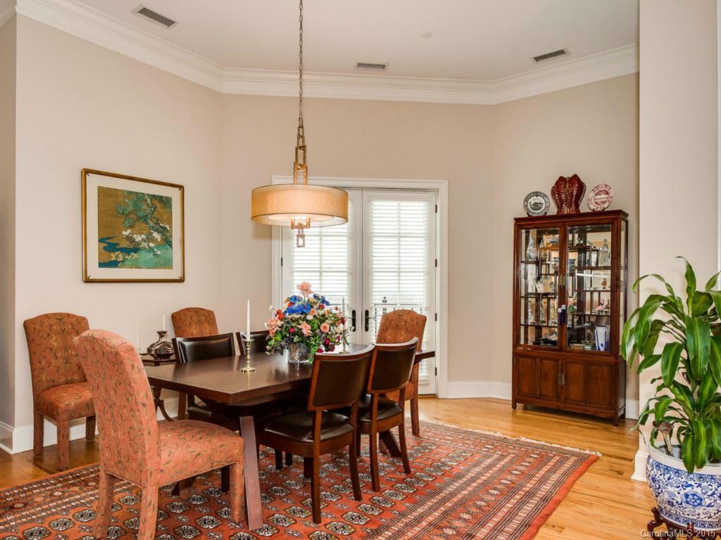 2823 Providence Road, Unit 180 Charlotte, NC 28211 - Photo 7 of 24 a dining room with furniture potted plants and wooden floor