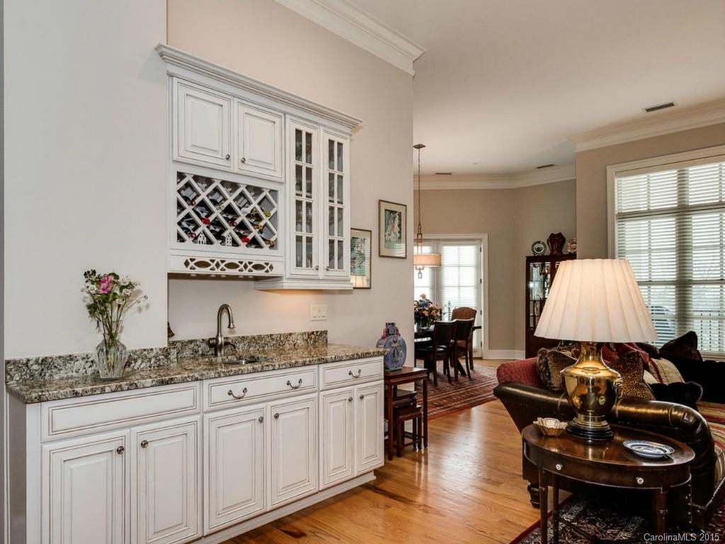 2823 Providence Road, Unit 180 Charlotte, NC 28211 - Photo 10 of 24 a kitchen with granite countertop a sink dishwasher a dining table and chairs with wooden floor